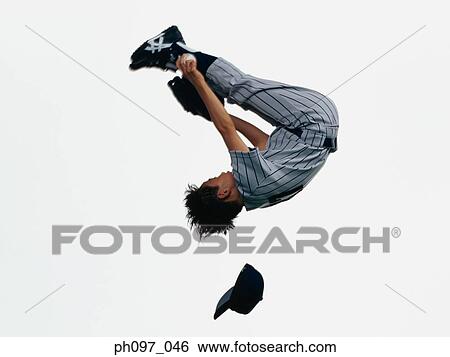 Young Baseball player catching ball in glove in mid-air View Large Photo Image Stock Photograph - Young Baseball player catching ball in glove in mid-air. Fotosearch