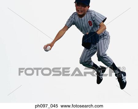 Stock Photography - Young Baseball player catching ball in glove in mid-air. Fotosearch