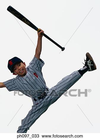 Stock Image - Young Baseball player holding bat in mid-air. Fotosearch