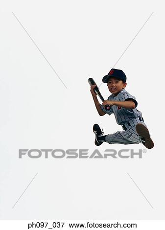 Stock Photo - Young Baseball player holding bat in mid-air. Fotosearch