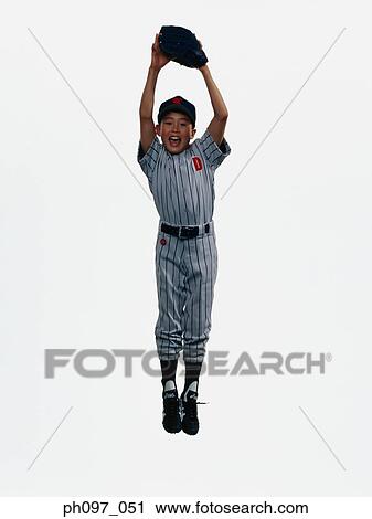 Young Baseball player in baseball glove, jumping in mid-air View Large Photo Image Stock Image - Young Baseball player in baseball glove, jumping in mid-air. Fotosearch