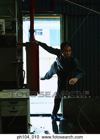 Man balancing on one leg looking around interior View Large Photo Image Stock Image - Man balancing on one leg looking around interior. Fotosearch