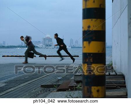 Man chasing another at jetty View Large Photo Image Stock Image - Man chasing another at jetty. Fotosearch