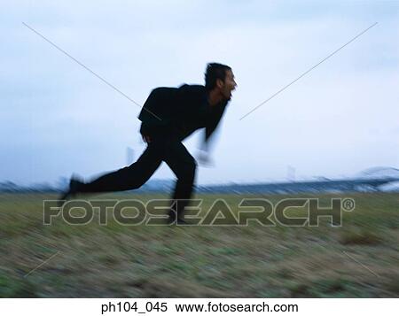 Man dashing across the field, blur motion View Large Photo Image Stock Photography - Man dashing across the field, blur motion. Fotosearch