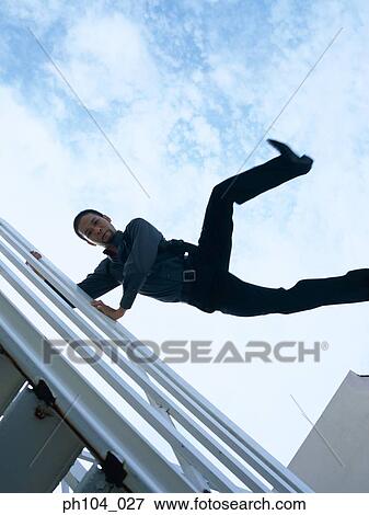 Man jump over railing, view from below View Large Photo Image Stock Photo - Man jump over railing, view from below. Fotosearch