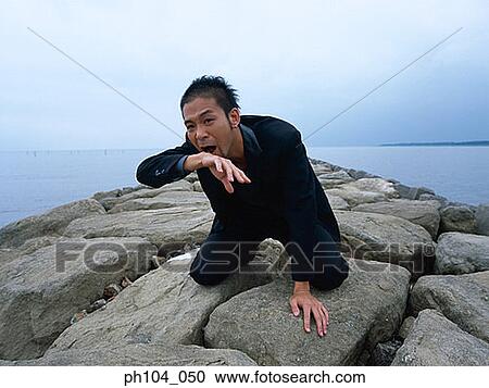 Man kneeling, wiping blood near mouth View Large Photo Image Stock Image - Man kneeling, wiping blood near mouth. Fotosearch