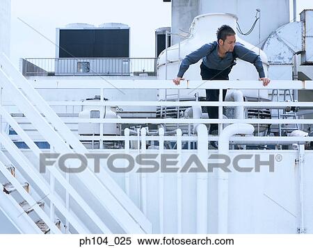 Man looking over railings View Large Photo Image Stock Photography - Man looking over railings. Fotosearch