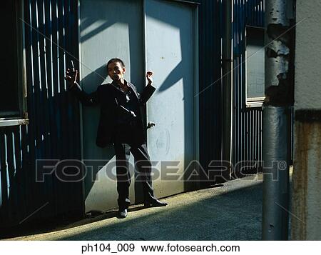 Man with gun at the door View Large Photo Image Stock Photo - Man with gun at the door. Fotosearch