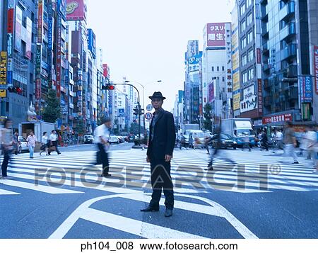 Man with hat and suit, standing in the middle of junction View Large Photo Image Stock Photo - Man with hat and suit, standing in the middle of junction. Fotosearch
