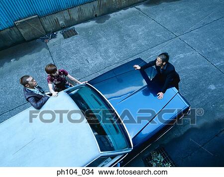 Picture - Three people negotiating, view from top. Fotosearch