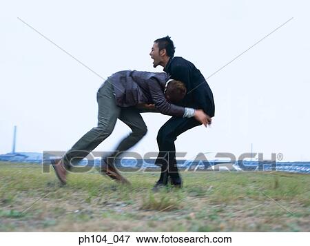 Stock Photo - Two men fighting, blur motion. Fotosearch