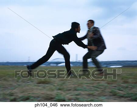 Two men fighting, blur motion View Large Photo Image Stock Photograph - Two men fighting, blur motion. Fotosearch