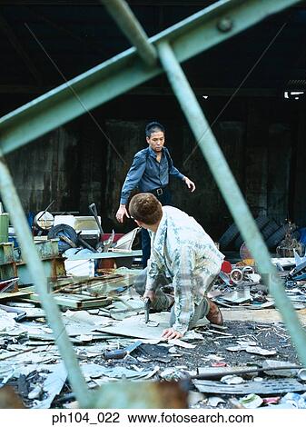 Stock Image - Two men fighting, one with gun in his hand. Fotosearch