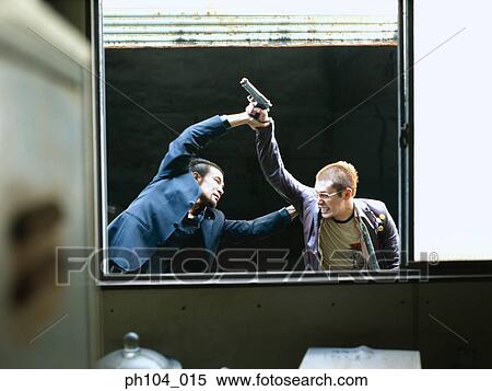 Stock Photography - Two men struggling, one with a gun in his hand. Fotosearch