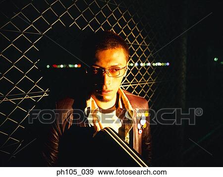 Light shines on a man holding a briefcase View Large Photo Image Stock Photo - Light shines on a man holding a briefcase. Fotosearch