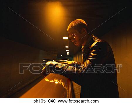 Man leaning on railing, at night View Large Photo Image Stock Image - Man leaning on railing, at night. Fotosearch