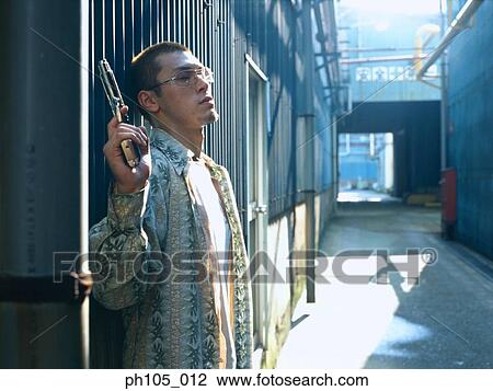 Man standing at the door, gun in his hand View Large Photo Image Stock Image - Man standing at the door, gun in his hand. Fotosearch