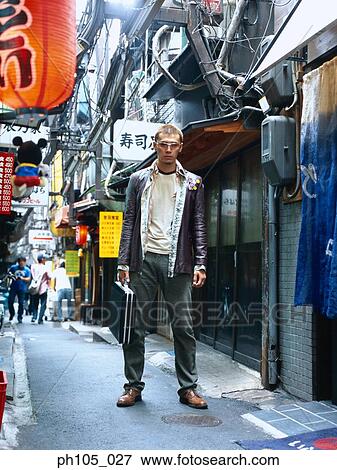 Man standing, holding a briefcase View Large Photo Image Stock Photo - Man standing, holding a briefcase. Fotosearch