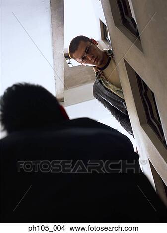 Two men meet face to face at stairwell View Large Photo Image Picture - Two men meet face to face at stairwell. Fotosearch