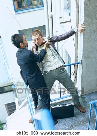 Two men struggling, high angle view View Large Photo Image Stock Image - Two men struggling, high angle view. Fotosearch