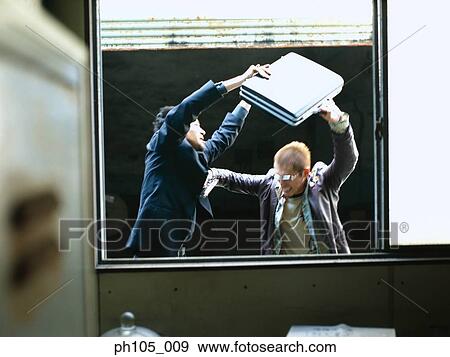Two men struggling over a briefcase, view from inside View Large Photo Image Stock Photo - Two men struggling over a briefcase, view from inside. Fotosearch