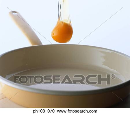 Egg yolk falling to pan View Large Photo Image Stock Image - Egg yolk falling to pan. Fotosearch