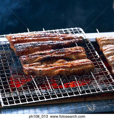Grilled eel over charcoal fire View Large Photo Image Stock Image - Grilled eel over charcoal fire. Fotosearch