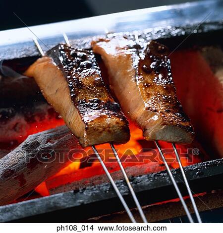 Grilled salmon pieces over charcoal fire View Large Photo Image Picture - Grilled salmon pieces over charcoal fire. Fotosearch