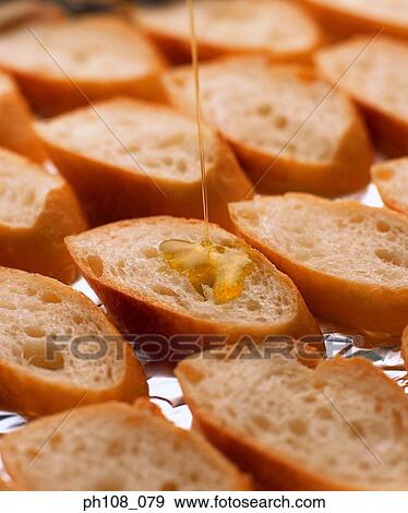 Olive oil on French loaf slices View Large Photo Image Stock Photo - Olive oil on French loaf slices. Fotosearch