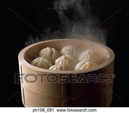 Stock Image - Steam buns in bamboo basket. Fotosearch