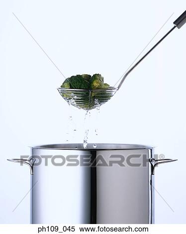 Broccoli in colander, draining water View Large Photo Image Stock Photography - Broccoli in colander, draining water. Fotosearch
