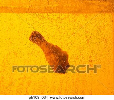 Chicken drumstick in boiling oil View Large Photo Image Picture - Chicken drumstick in boiling oil. Fotosearch