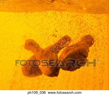 Chicken drumsticks in boiling oil View Large Photo Image Stock Photograph - Chicken drumsticks in boiling oil. Fotosearch