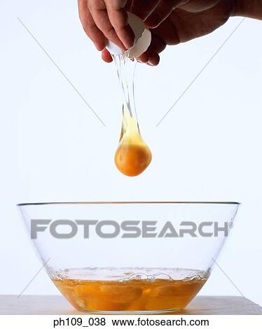 Hands cracking egg View Large Photo Image Stock Photo - Hands cracking egg . Fotosearch