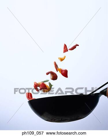 Tossing prawns and vegetables with wok View Large Photo Image Stock Photo - Tossing prawns and vegetables with wok. Fotosearch