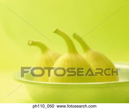 Stock Image - A bowl of fresh fig, yellow toned. Fotosearch