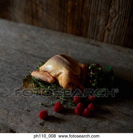 Marinated whole chicken on herb and berries View Large Photo Image Stock Photo - Marinated whole chicken on herb and berries. Fotosearch
