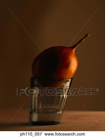 Stock Photo - Passion fruit sitting on a glass. Fotosearch