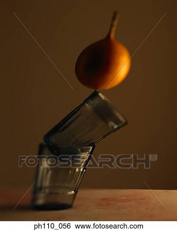Stacked glasses and a passion fruit View Large Photo Image Stock Photograph - Stacked glasses and a passion fruit. Fotosearch
