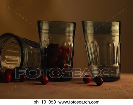 Stock Image - Three glasses, one filled with berries. Fotosearch