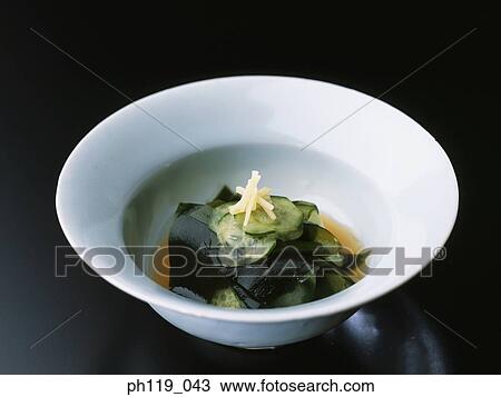 Stock Image - A bowl of seaweed and cucumber slices. Fotosearch