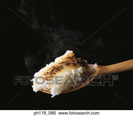 A spoonful of rice, partially overcooked View Large Photo Image Stock Photograph - A spoonful of rice, partially overcooked. Fotosearch