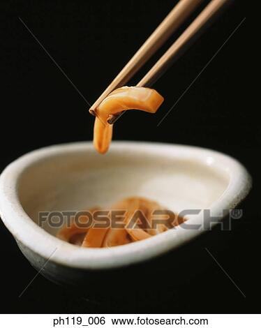 Chopsticks picking a slice of cuttlefish View Large Photo Image Stock Photograph - Chopsticks picking a slice of cuttlefish. Fotosearch