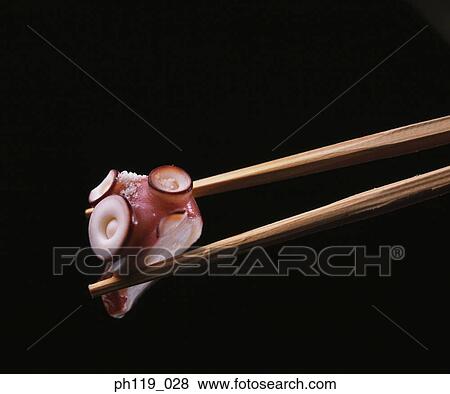 Chopsticks picking a slice of octopus (Tako) View Large Photo Image Stock Photo - Chopsticks picking a slice of octopus (Tako). Fotosearch