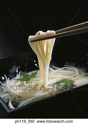 Chopsticks picking noodles from bowl View Large Photo Image Stock Image - Chopsticks picking noodles from bowl. Fotosearch