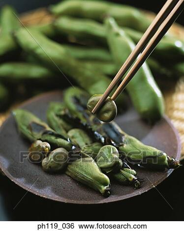 Chopsticks picking seed from a plate of edamame View Large Photo Image Stock Photograph - Chopsticks picking seed from a plate of edamame . Fotosearch