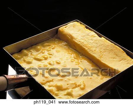 Stock Image - Cooking omelette in a pan. Fotosearch