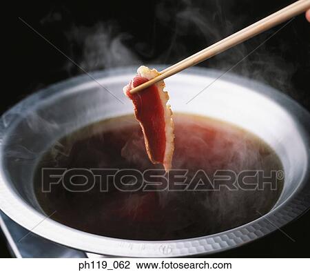 Dipping a slice of beef in hot soup View Large Photo Image Stock Image - Dipping a slice of beef in hot soup. Fotosearch