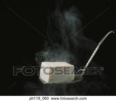 Scooping up a cube of bean curd View Large Photo Image Stock Image - Scooping up a cube of bean curd. Fotosearch