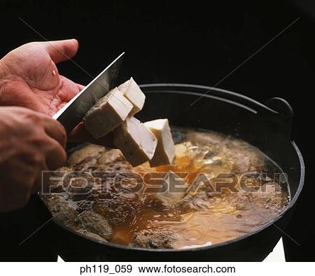 Slicing bean curd in boiling soup View Large Photo Image Stock Photo - Slicing bean curd in boiling soup. Fotosearch